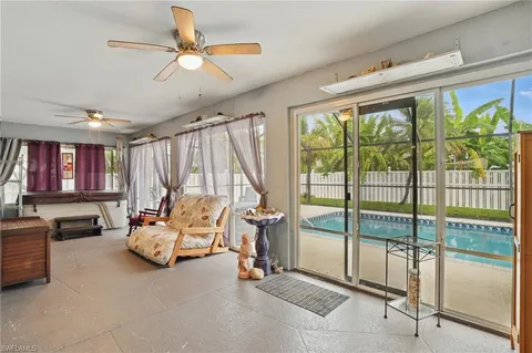 a bedroom with furniture and large window