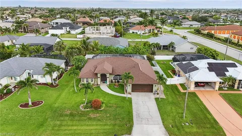 an aerial view of multiple houses with yard