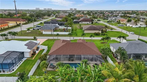 an aerial view of multiple houses with a yard