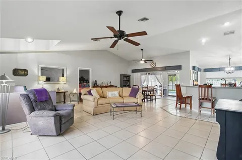 a living room with furniture and kitchen view