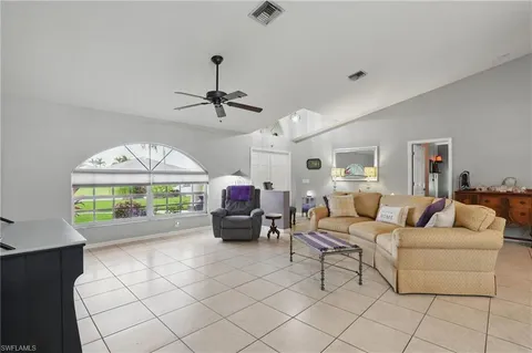 a living room with furniture a fireplace and a large window