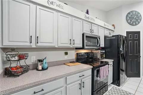 a kitchen with stainless steel appliances granite countertop a refrigerator a stove and a cabinets