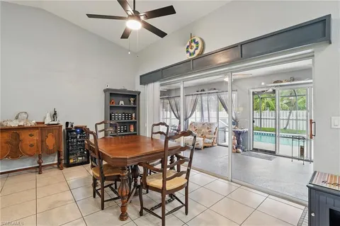 a dining room with furniture and a floor to ceiling window