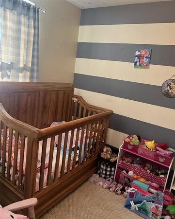 a bedroom with furniture and a window