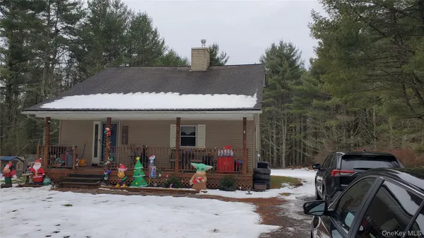a view of a patio with table and chairs under an umbrella