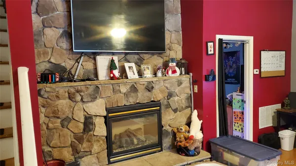 a view of living room with furniture and a fireplace