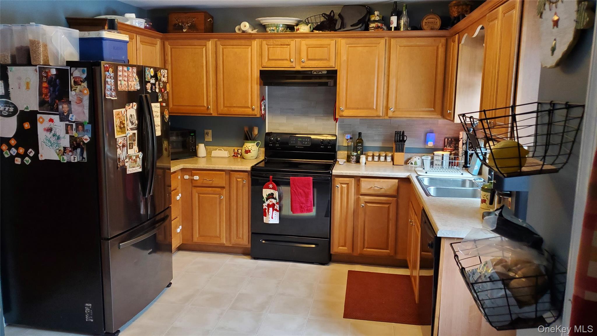 807 Beaver Brook Road Narrowsburg, NY 12764 - Photo 6 of 25 Kitchen featuring black appliances, light countertops, brown cabinetry, and decorative backsplash