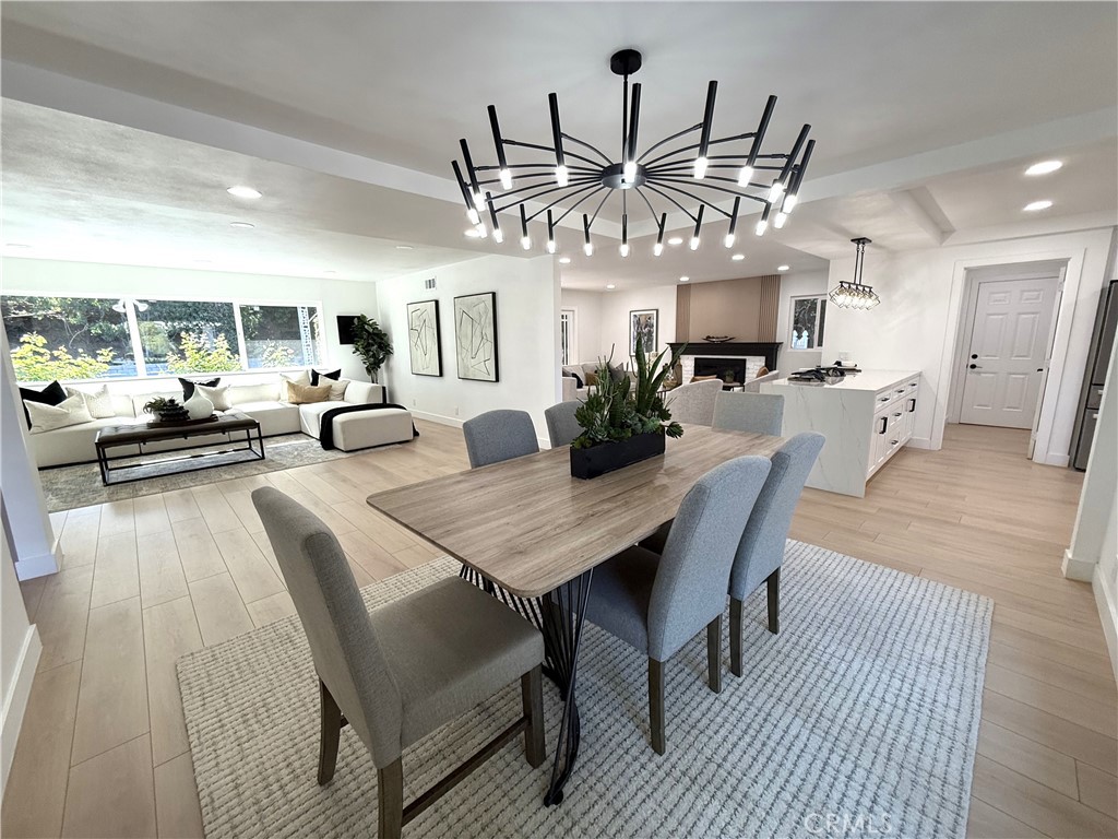 2225 Terraza Place Fullerton, CA 92835 - Photo 17 of 73 a view of a dining room with furniture a chandelier and wooden floor