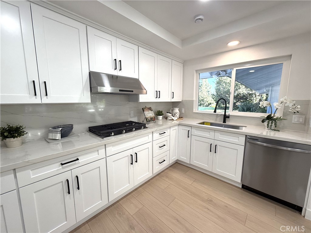 2225 Terraza Place Fullerton, CA 92835 - Photo 22 of 73 a kitchen with granite countertop white cabinets white appliances and sink
