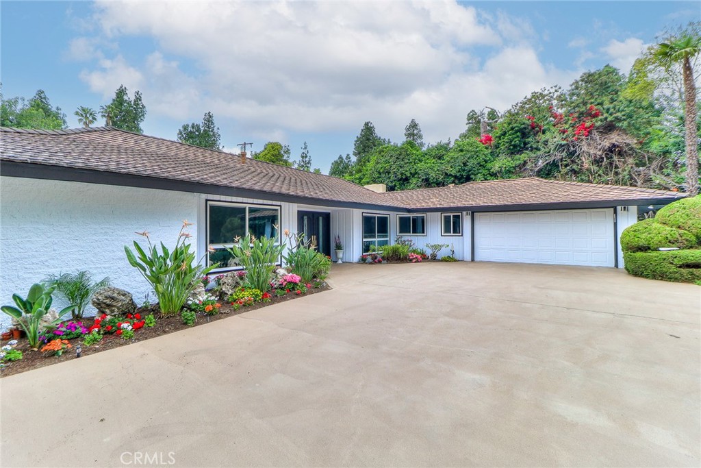 2225 Terraza Place Fullerton, CA 92835 - Photo 7 of 73 a front view of a house with a yard and a garage