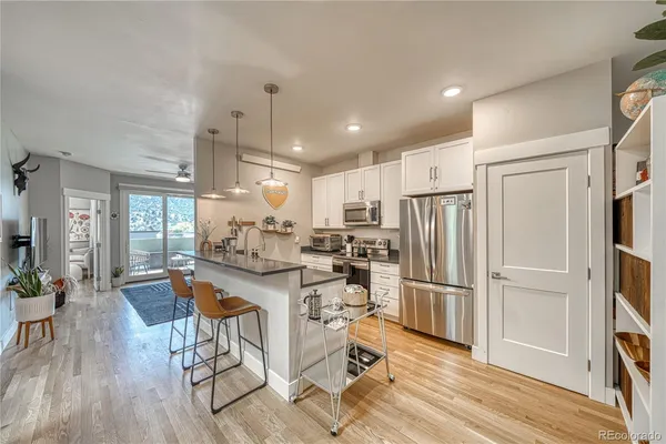 a kitchen with stainless steel appliances granite countertop a refrigerator and a stove top oven