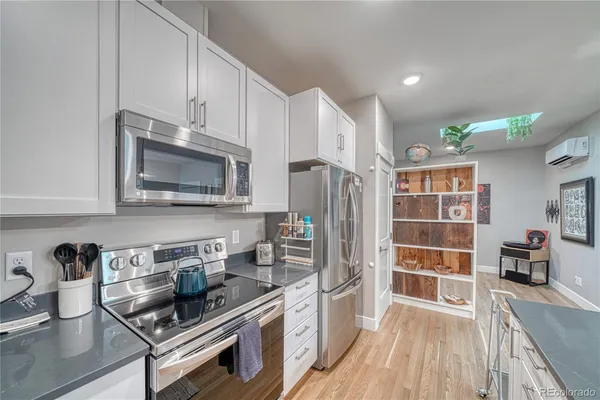 a kitchen with stainless steel appliances a stove a sink and a microwave