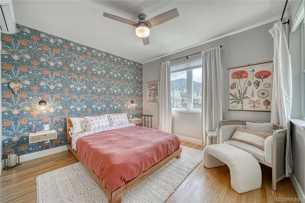 a bedroom with a large bed couch and a window