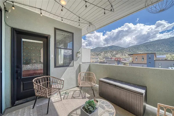 a balcony with table and chairs