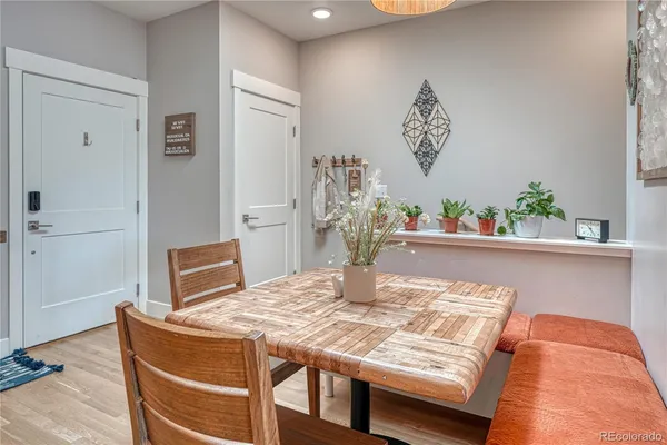 a dining room with furniture and wooden floor