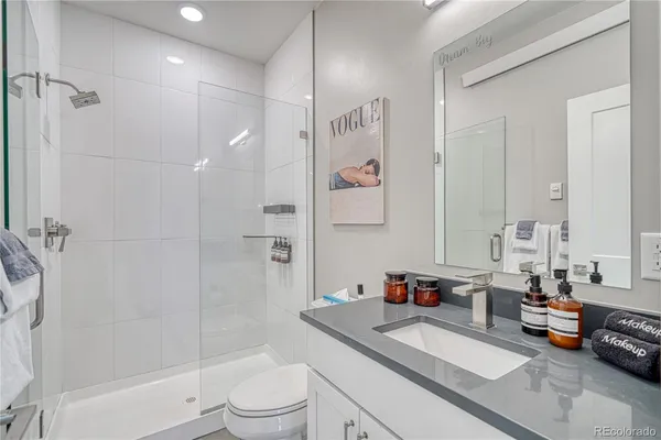 a spacious bathroom with a sink a toilet and shower