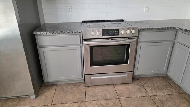 a view of hallway with window and wooden floor