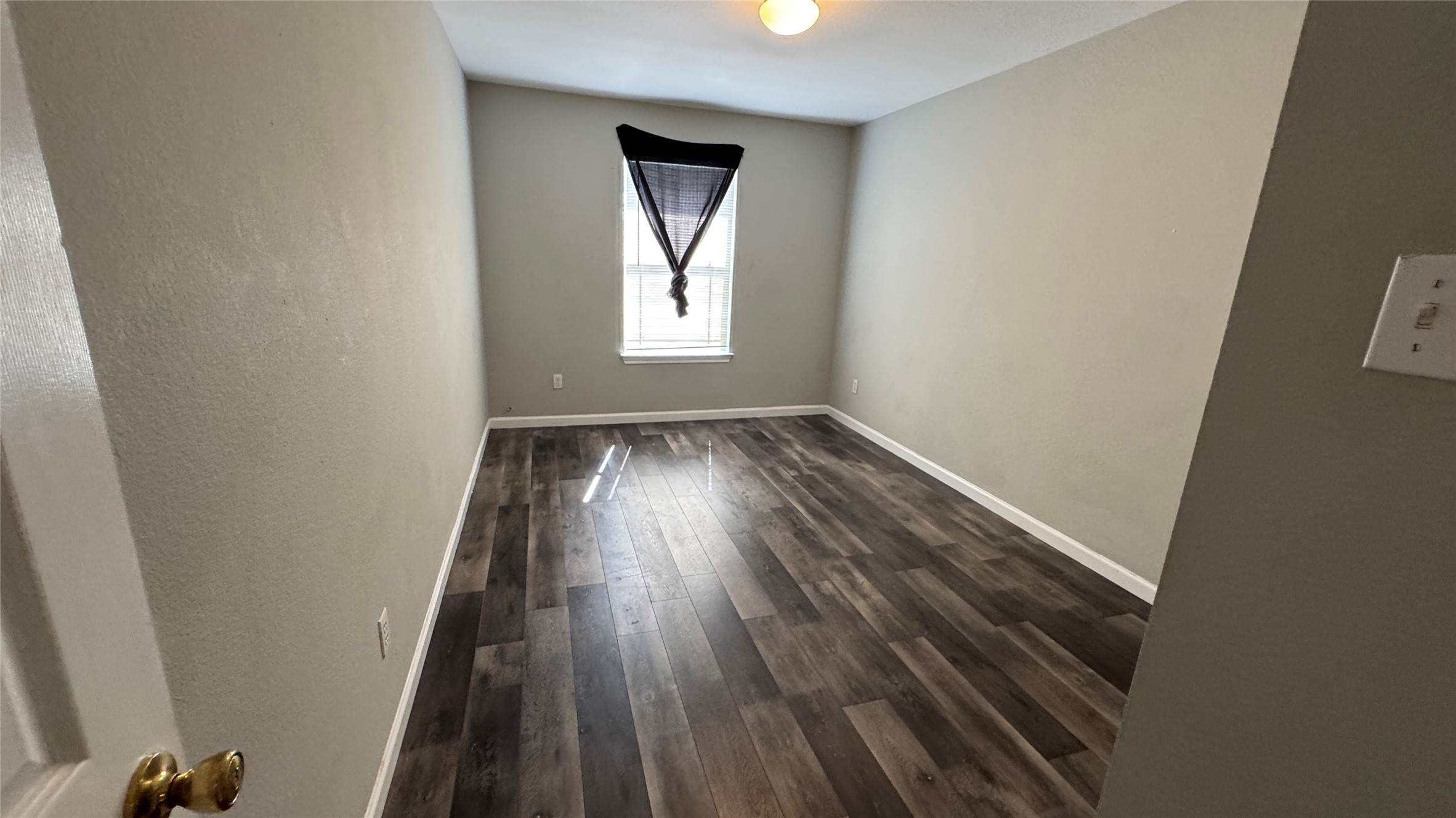 5605 Clyde Lane Austin, TX 78754 - Photo 19 of 26 an empty room with wooden floor and windows