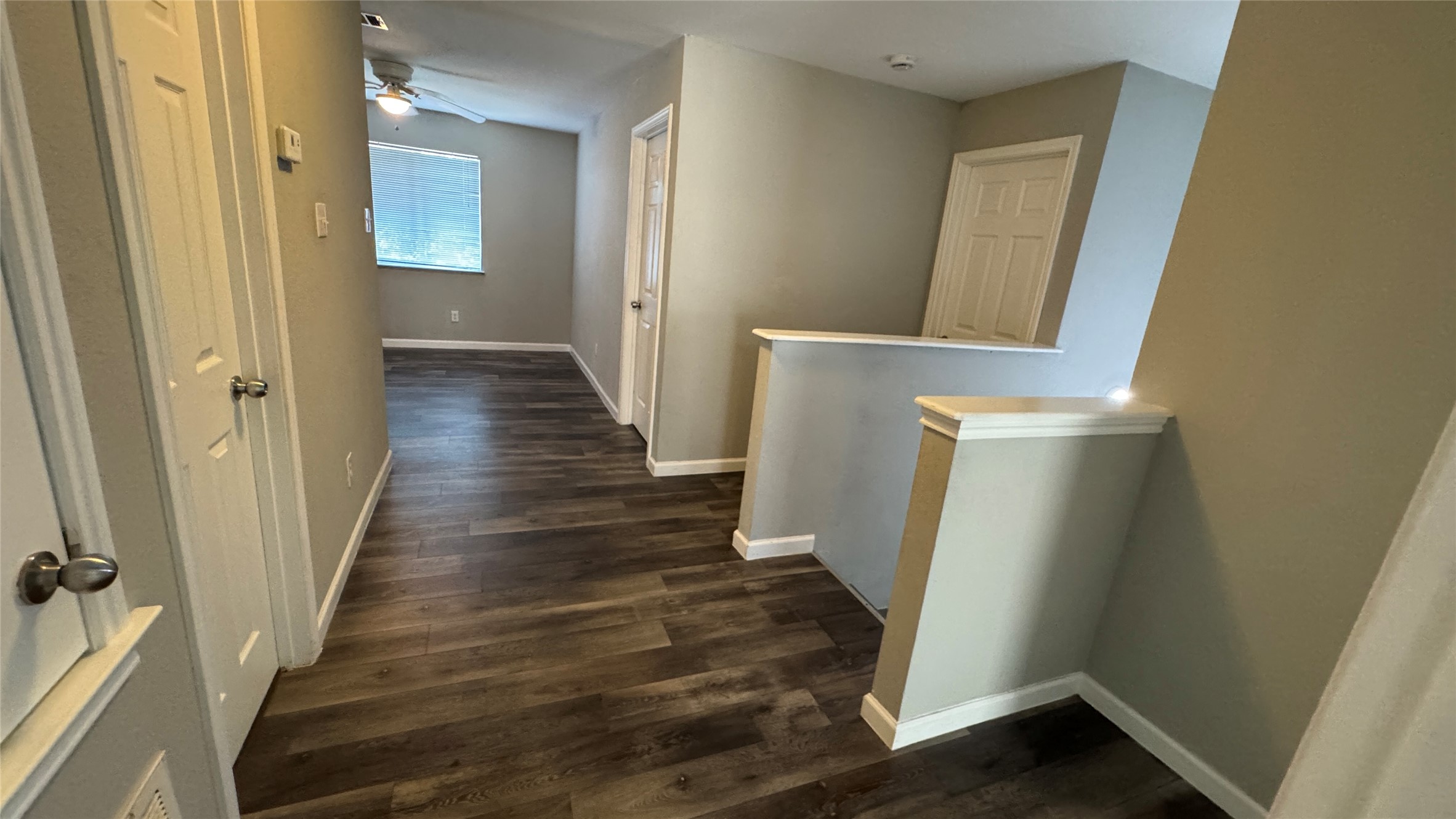 5605 Clyde Lane Austin, TX 78754 - Photo 22 of 26 a view of a hallway with wooden floor and staircase