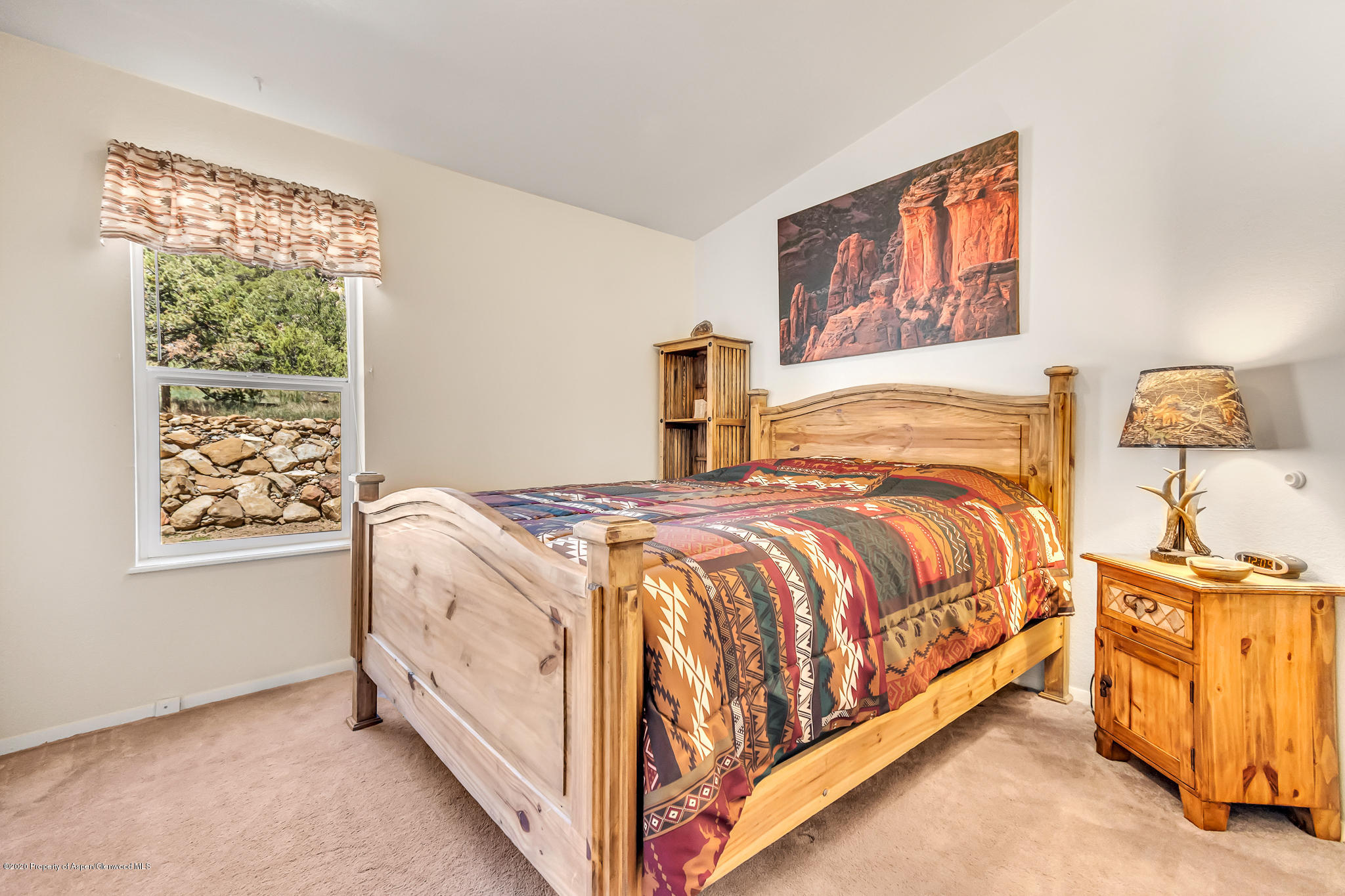 1205 County Road 252 Rifle, CO 81650 - Photo 20 of 37 a spacious bedroom with a bed and window
