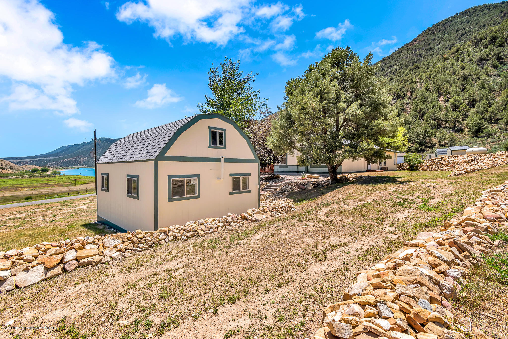 1205 County Road 252 Rifle, CO 81650 - Photo 24 of 37 a view of a wooden house with a yard