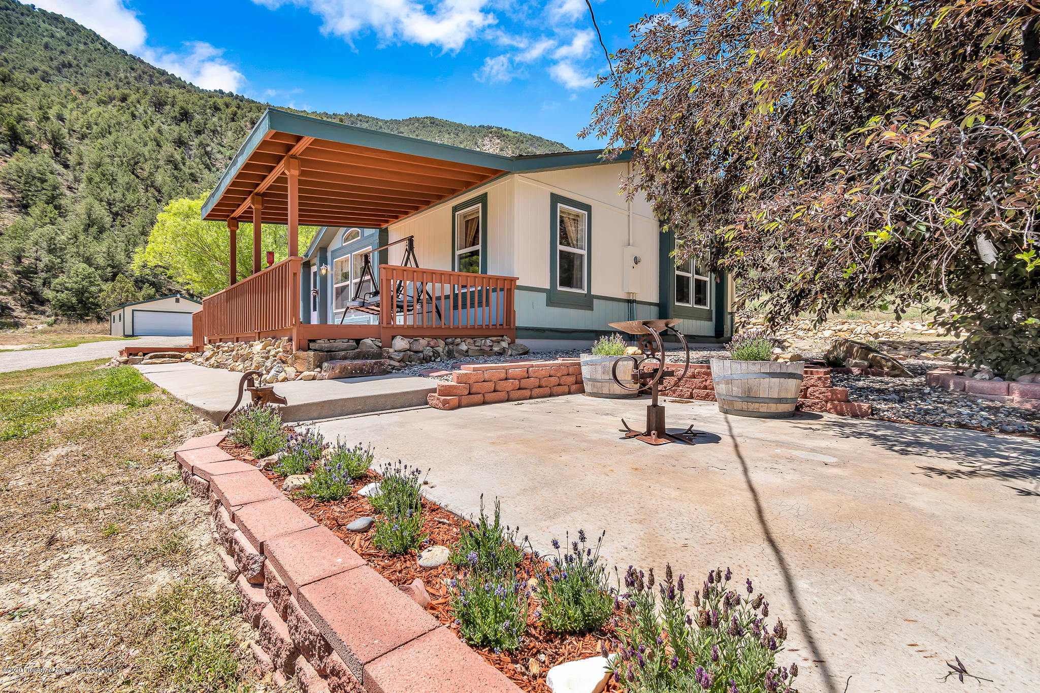1205 County Road 252 Rifle, CO 81650 - Photo 26 of 37 a view of a patio with a table and chairs under an umbrella