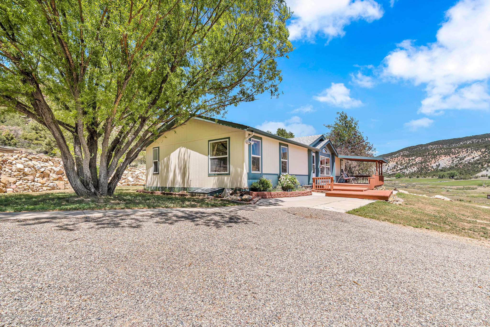 1205 County Road 252 Rifle, CO 81650 - Photo 28 of 37 a view of a house with backyard and a tree