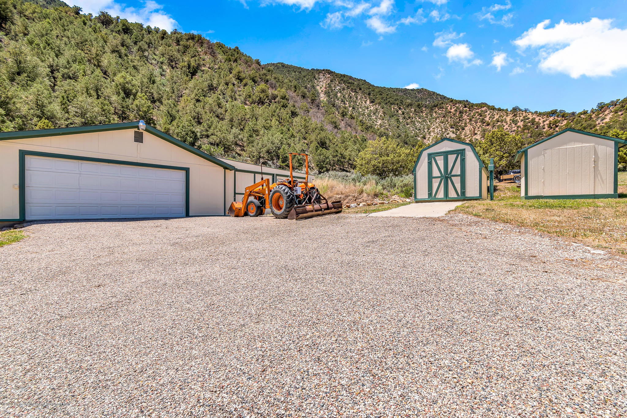 1205 County Road 252 Rifle, CO 81650 - Photo 30 of 37 a view of a large house with a mountain in the background