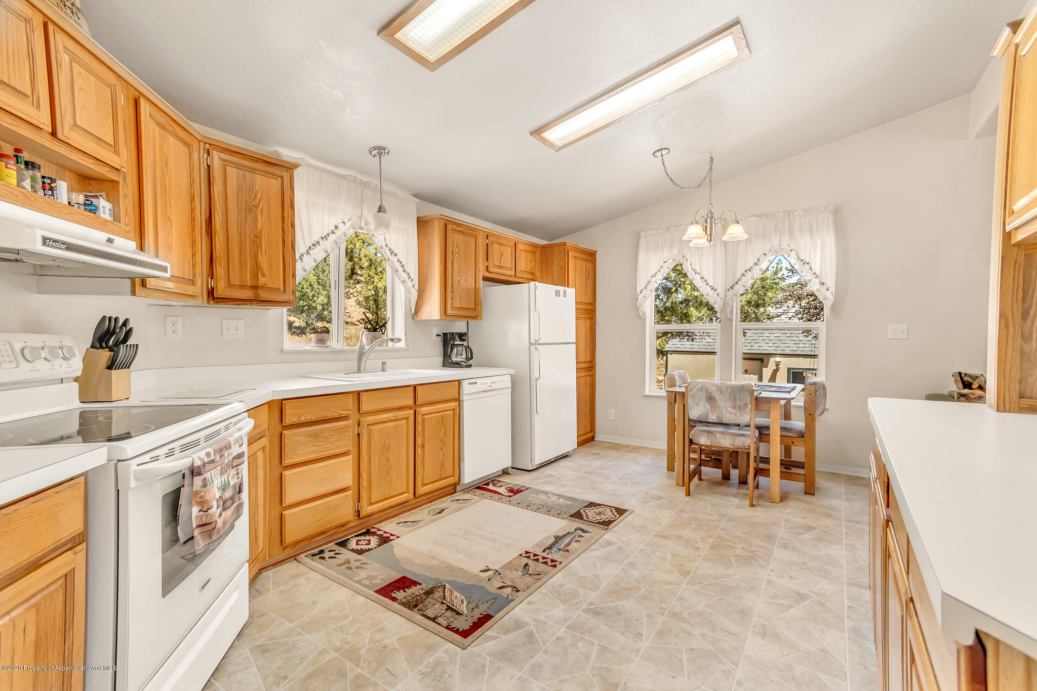 1205 County Road 252 Rifle, CO 81650 - Photo 3 of 37 a kitchen with sink cabinets and dining table
