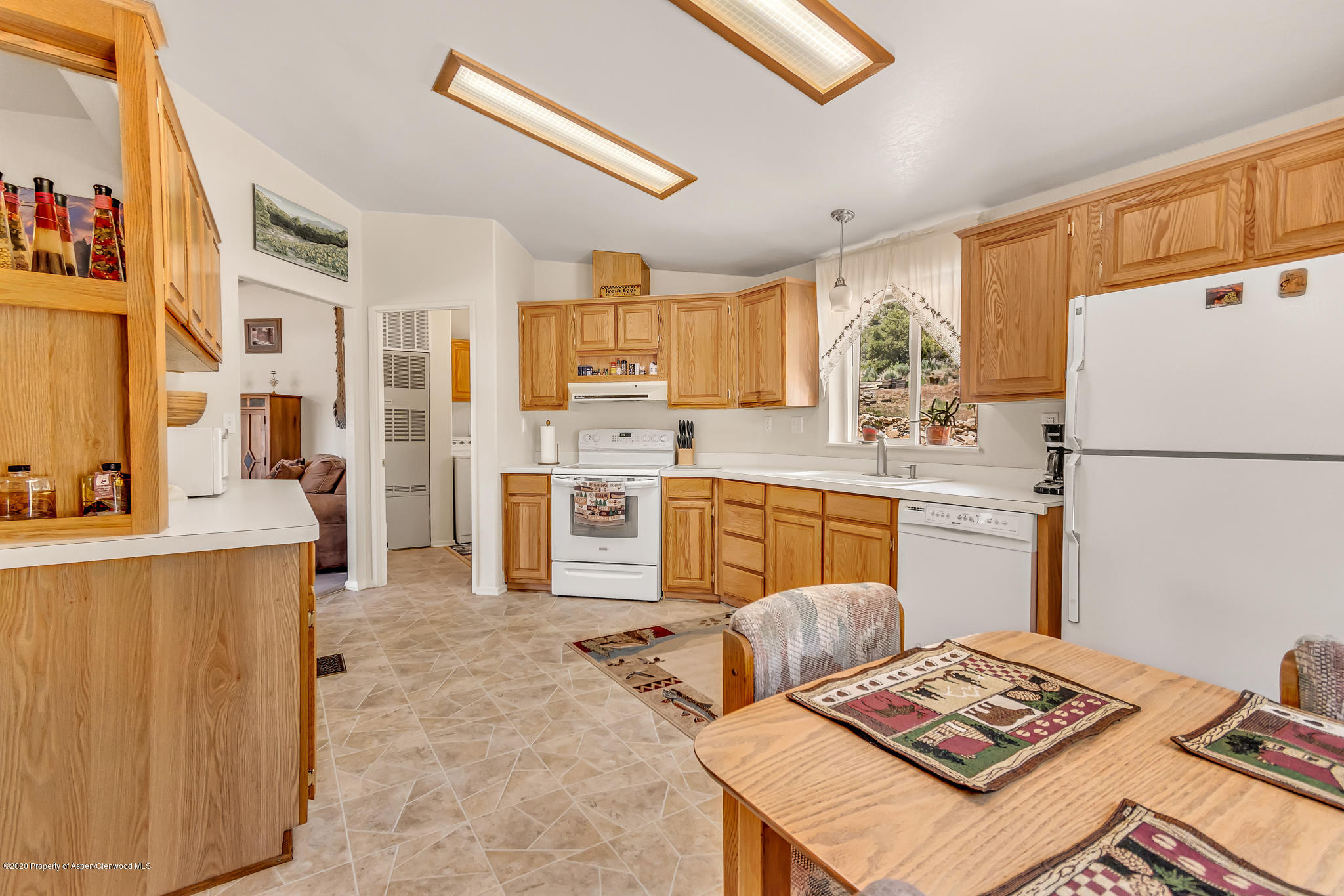 1205 County Road 252 Rifle, CO 81650 - Photo 4 of 37 a kitchen with a refrigerator and a stove top oven