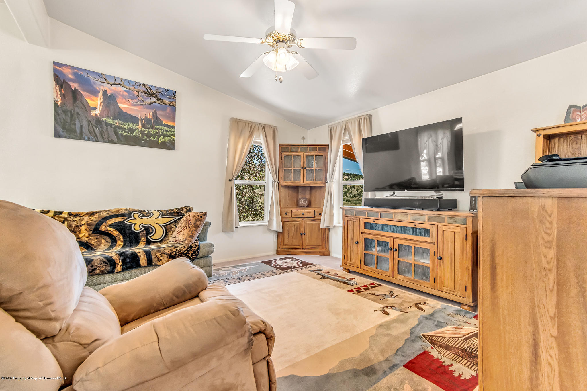 1205 County Road 252 Rifle, CO 81650 - Photo 7 of 37 a living room with furniture and a flat screen tv