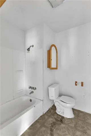 a bathroom with a toilet a sink and a bathtub