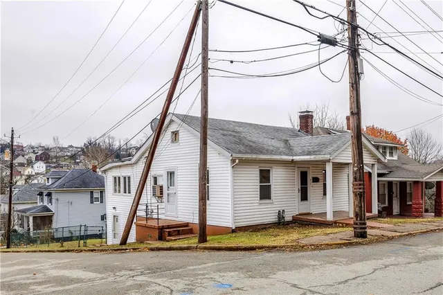 a view of a house with wooden floor and a small yard