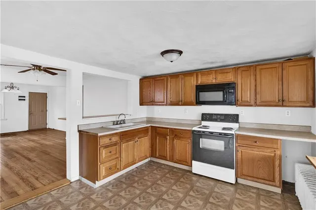 a kitchen with stainless steel appliances granite countertop a stove sink and microwave