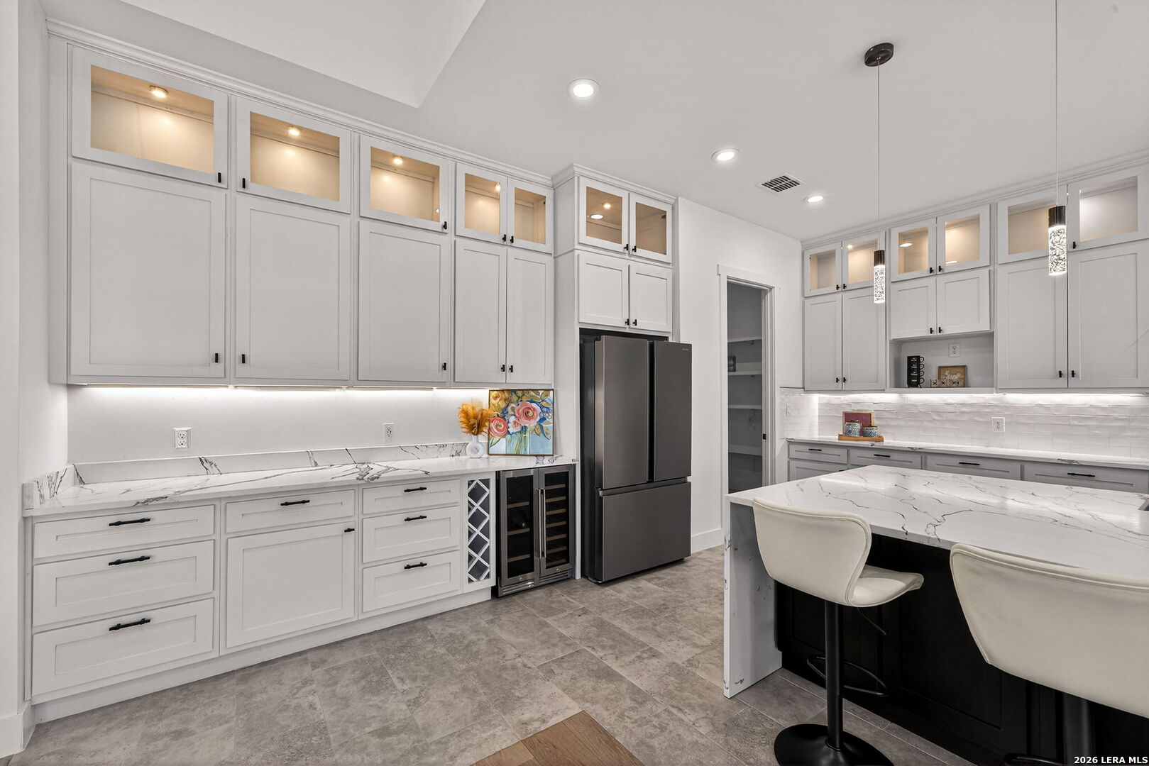 344 Buckskin Trail Bandera, TX 78003 - Photo 13 of 50 a kitchen with a refrigerator a sink and chairs