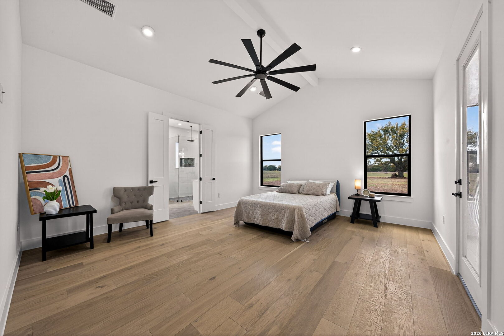 344 Buckskin Trail Bandera, TX 78003 - Photo 20 of 50 a bedroom with a bed and a chandelier