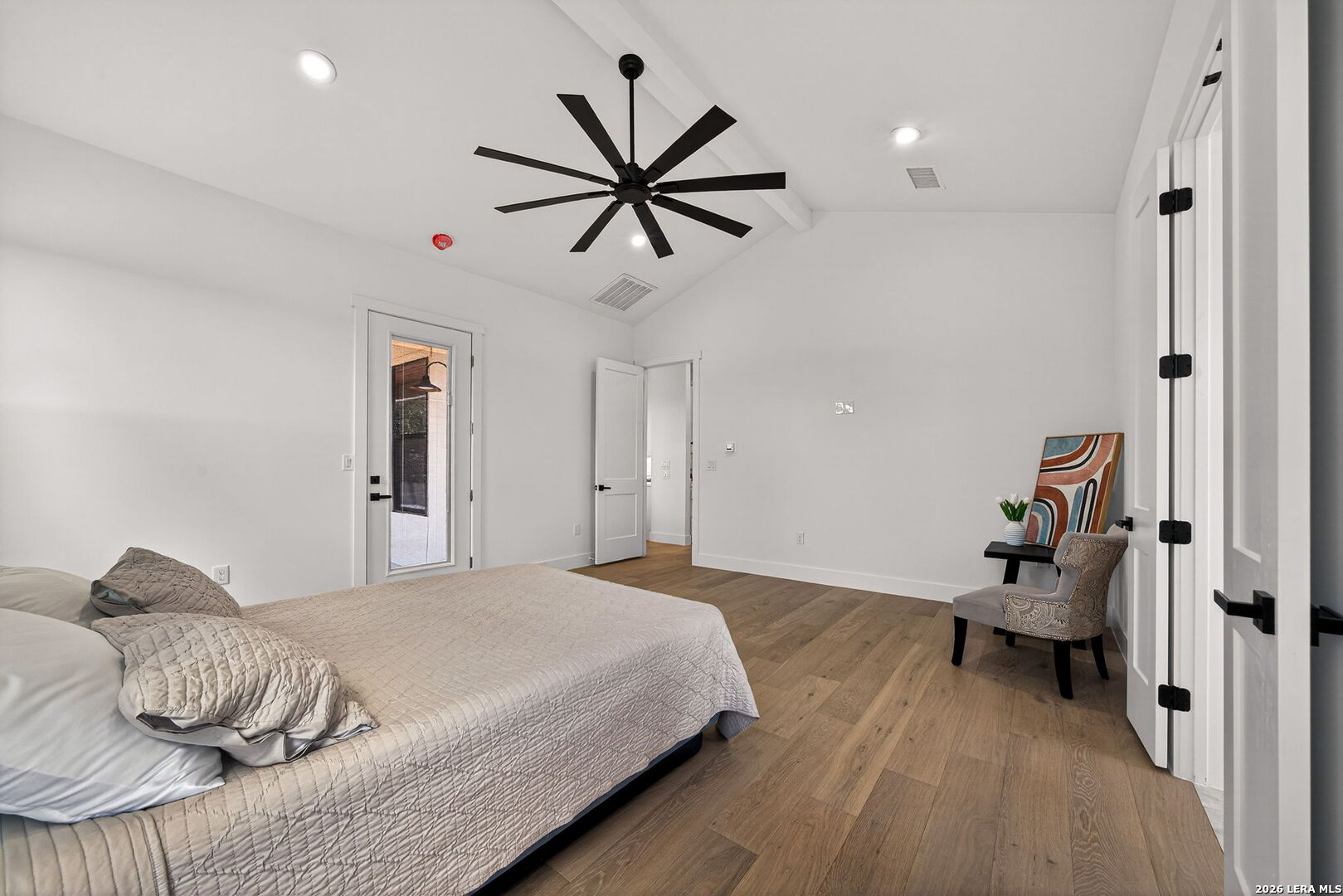 344 Buckskin Trail Bandera, TX 78003 - Photo 21 of 50 a bedroom with a bed and wooden floor