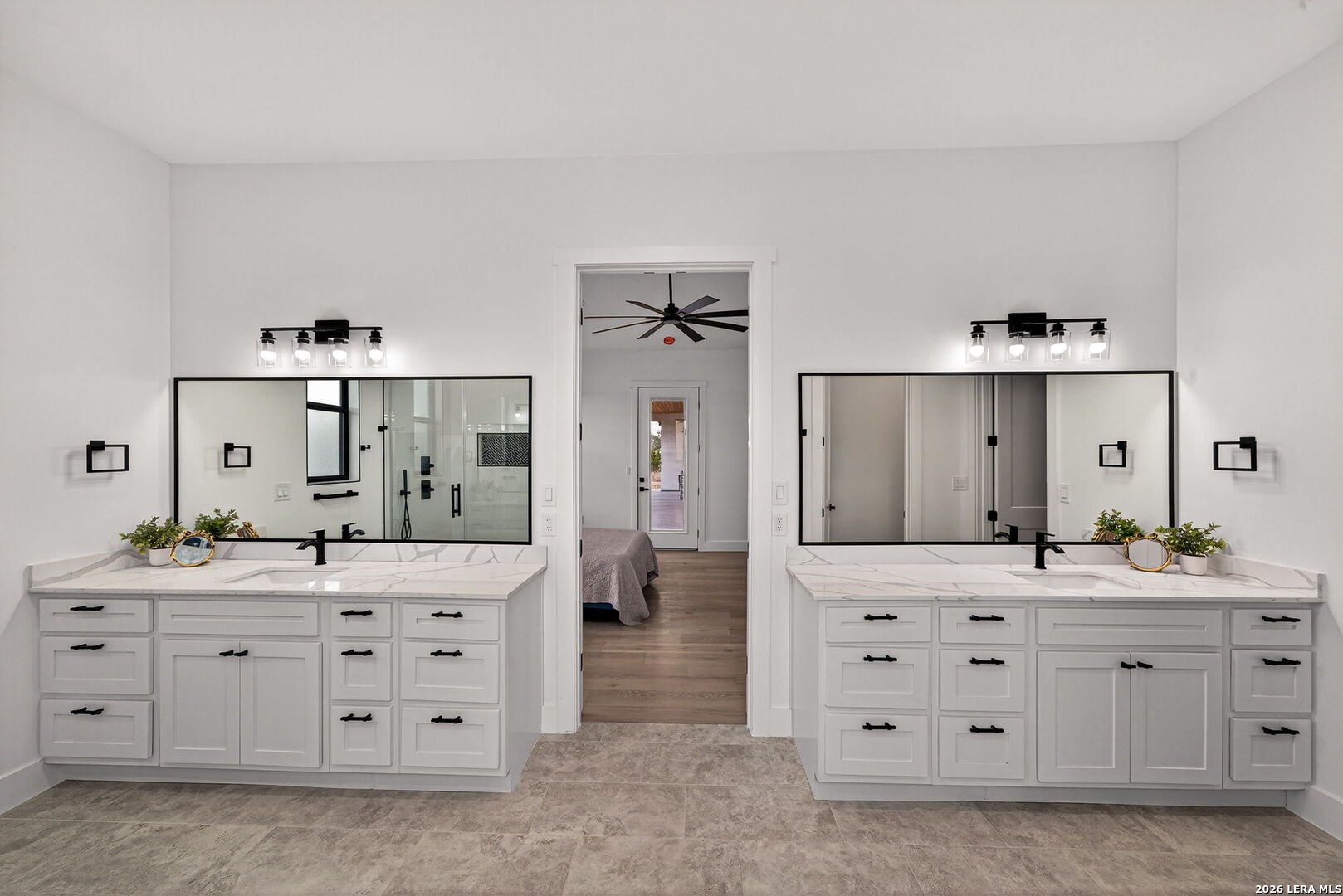 344 Buckskin Trail Bandera, TX 78003 - Photo 25 of 50 a spacious bathroom with a double vanity sink and a mirror