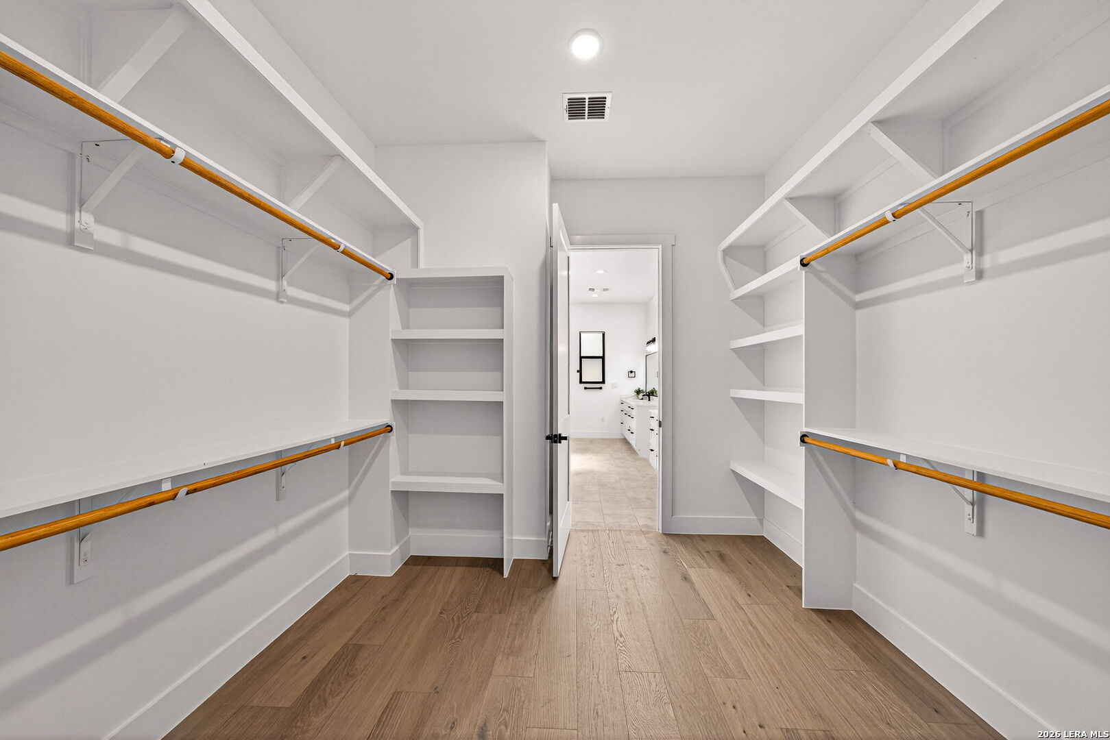 344 Buckskin Trail Bandera, TX 78003 - Photo 28 of 50 a view of walk in closet with wooden floor and stairs