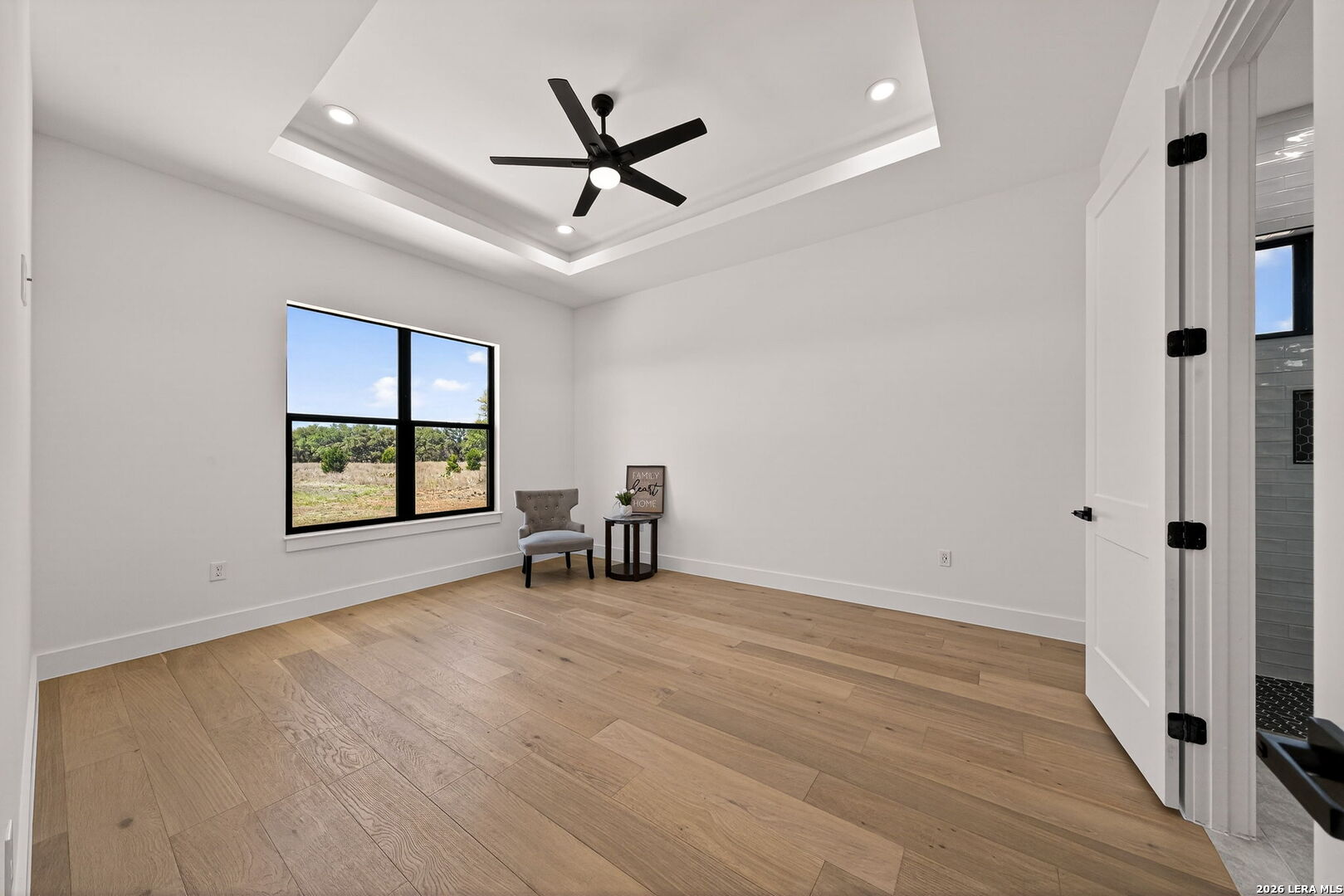344 Buckskin Trail Bandera, TX 78003 - Photo 30 of 50 a view of an empty room with a window and wooden floor