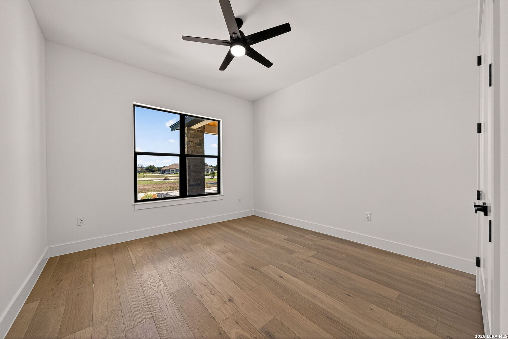 344 Buckskin Trail Bandera, TX 78003 - Photo 33 of 50 an empty room with window and ceiling fan