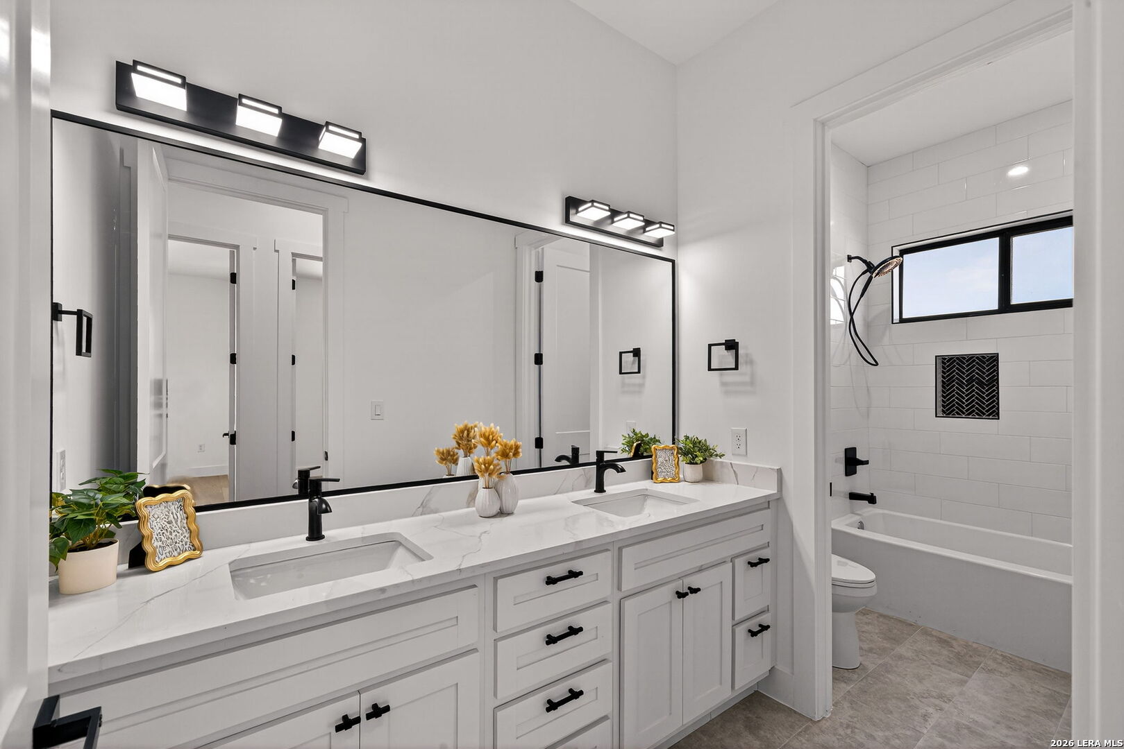 344 Buckskin Trail Bandera, TX 78003 - Photo 34 of 50 a bathroom with a double vanity sink and mirror with shower