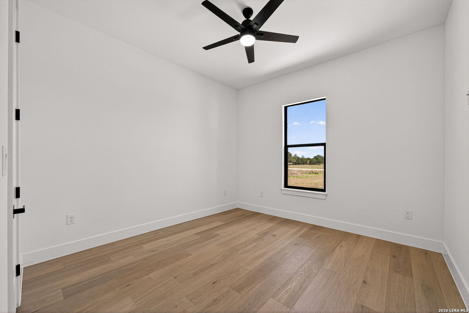 344 Buckskin Trail Bandera, TX 78003 - Photo 35 of 50 an empty room with a window and a ceiling fan