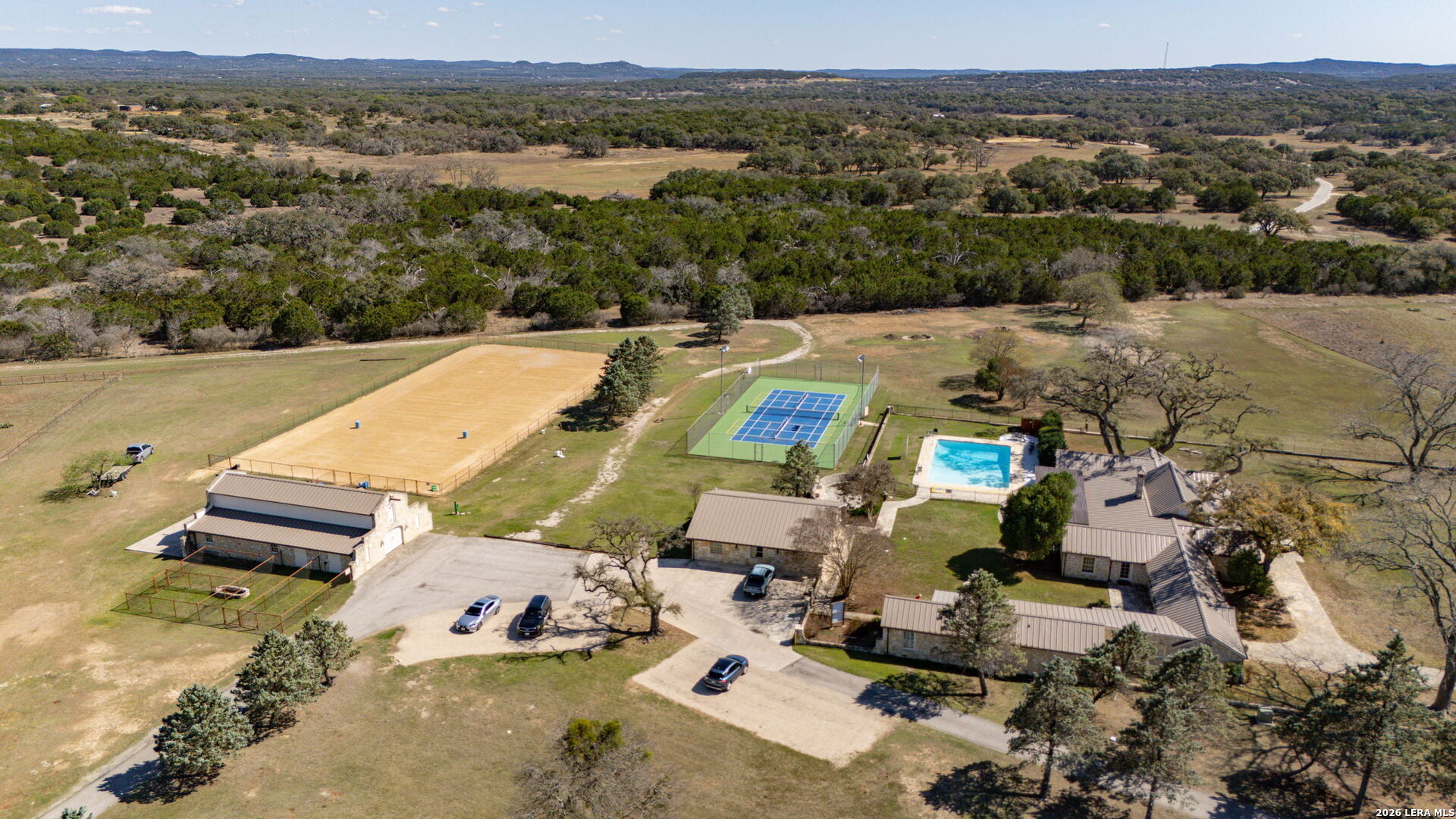344 Buckskin Trail Bandera, TX 78003 - Photo 47 of 50 an aerial view of a house with a swimming pool and mountains