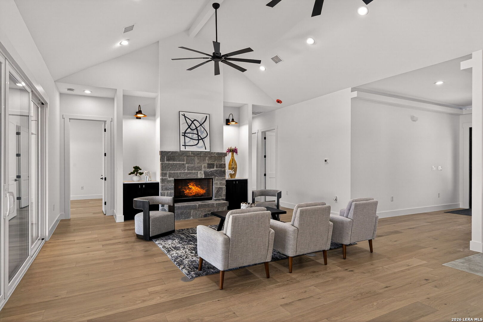 344 Buckskin Trail Bandera, TX 78003 - Photo 6 of 50 a living room with furniture a fireplace and a chandelier