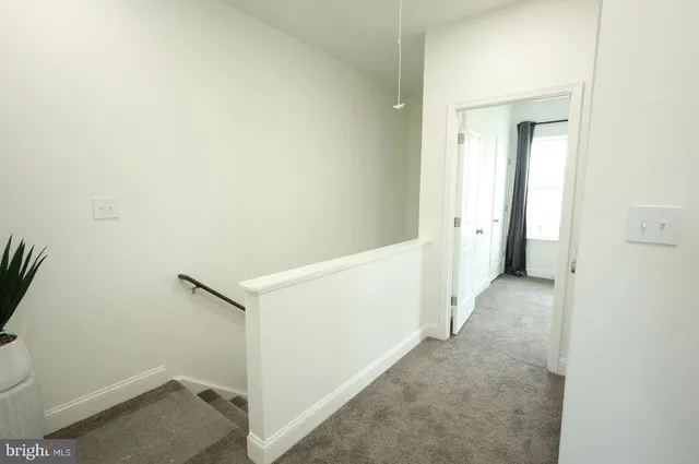 a bathroom with a toilet and a painting on the wall