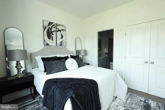 a bed room with a bed and a painting