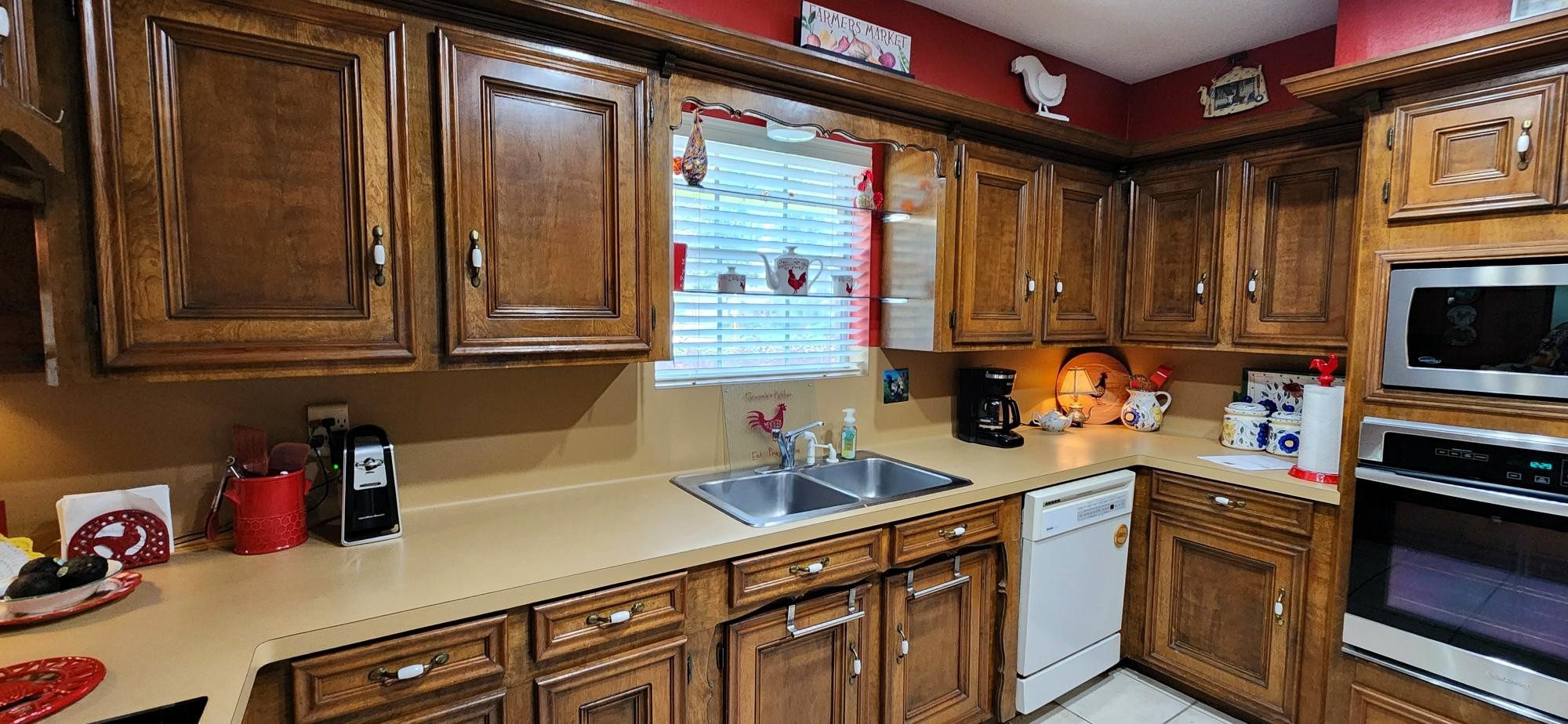 16155 Hexham Drive Spring, TX 77379 - Photo 17 of 47 a kitchen with stainless steel appliances a sink dishwasher stove and cabinets