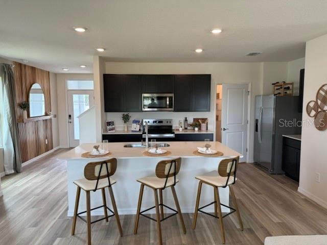 10507 Tucker Road Weeki Wachee, FL 34613 - Photo 6 of 39 a kitchen with stainless steel appliances granite countertop a dining table chairs refrigerator and microwave