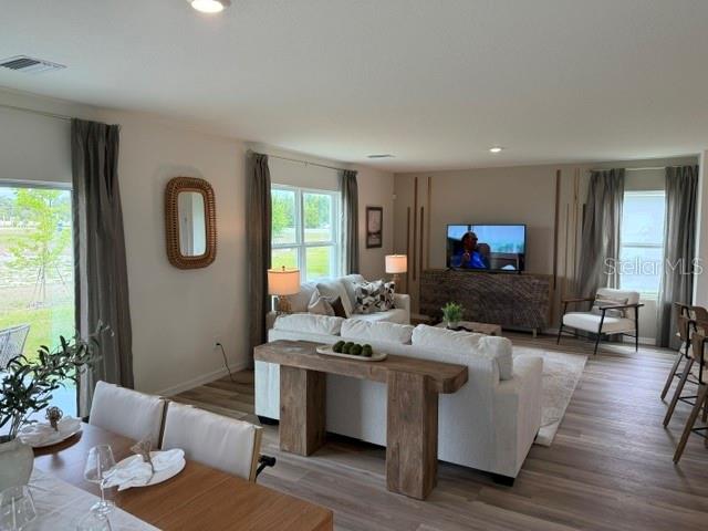 10507 Tucker Road Weeki Wachee, FL 34613 - Photo 8 of 39 a living room with furniture a window and a flat screen tv